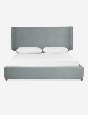 Valen dove blue velvet upholstered platform bed with a subtle winged headboard and oak wood legs