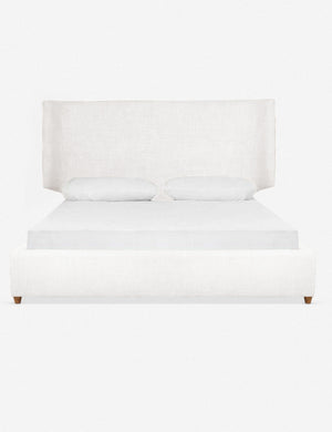 Valen white upholstered platform bed with a subtle winged headboard and oak wood legs