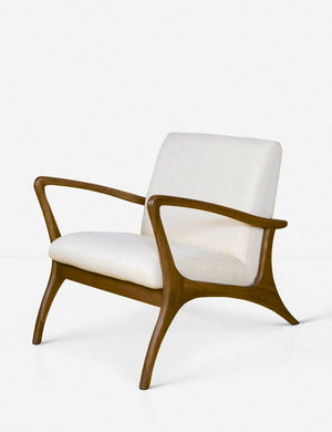Angled view of the Venturi white indoor and outdoor accent chair with wooden legs