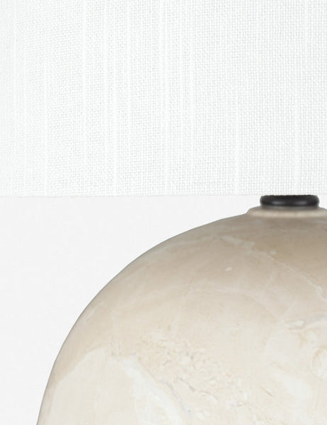 #color::tan | Close-up the shade and upper-half of the base of the Vivienne tan ceramic table lamp with spherical base