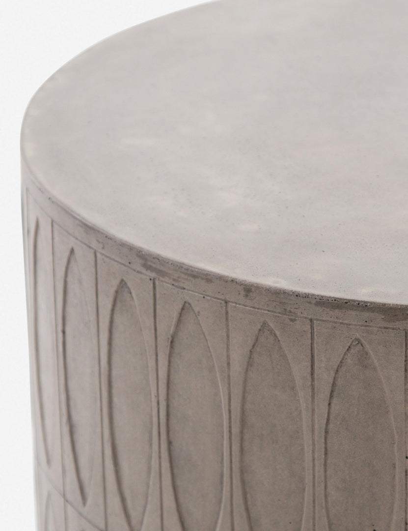 | Close-up of the upper half of the Glyn concrete indoor and outdoor side table with carved finish