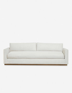 Walden white upholstered sofa with a wood plinth base and deep seats