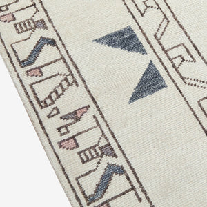 A close-up on the border of the Zehra hand-knotted ivory, gray and purple medallion wool-blend area rug