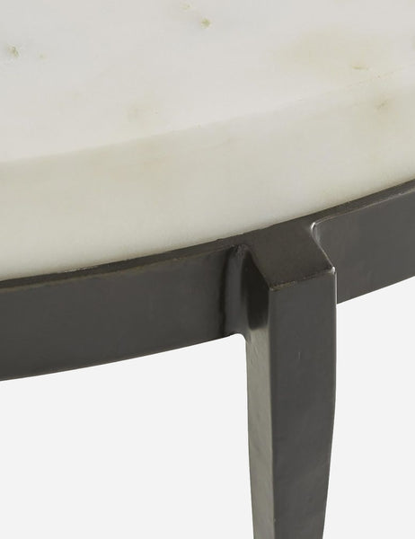 | Close-up of the side of the white marble top where it connects with the base